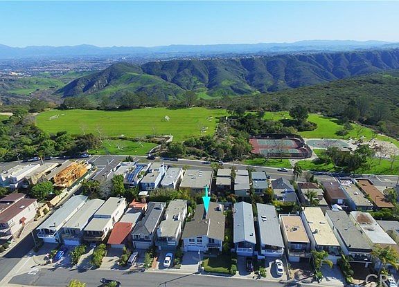 Aerial view showing Moulton Meadows Park & mountains behind the home.