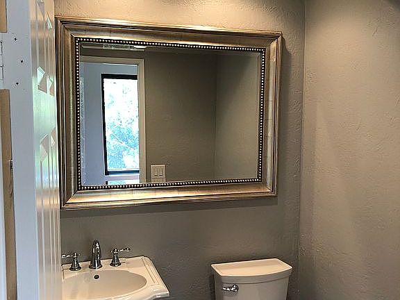 To left of front, 1/2 bath.