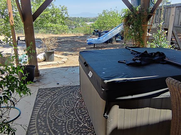 Mountain +Tree Tops Views / private jacuzzi / Yard is elevated with tons of privacy from neighbors / first covered pergola / huge space great for having friends over, or fur babies to run around / tons of space to garden your vegetables or flowers /