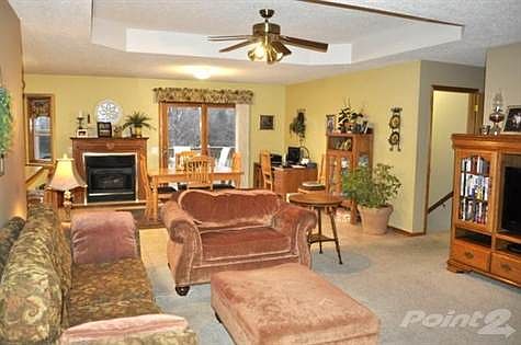 Livingroom and dining combo.  Vaulted ceiling feature.
