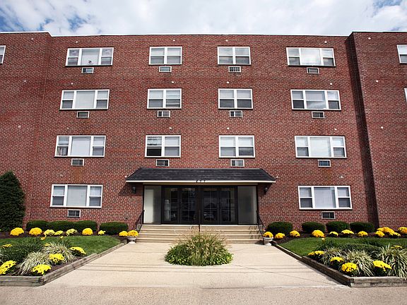 Welcome home to Audubon Arms Apartments_beautifully maintained grounds and a charming brick exterior.