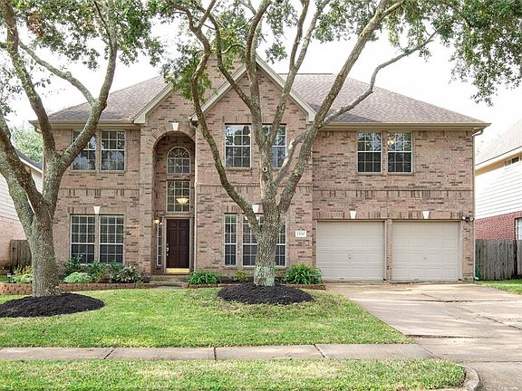The front of the home has excellent curb appeal with a brick elevation and extensive landscaping.