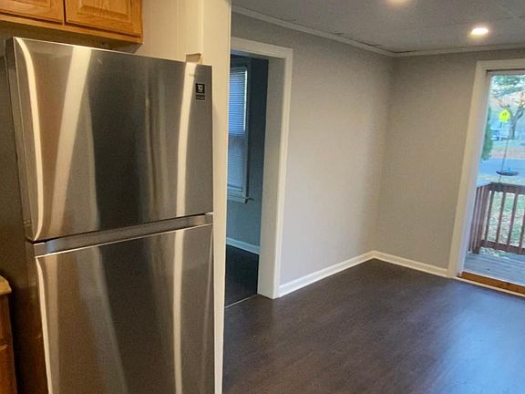 Spacious kitchen and dining area with brand new fridge and lots of light