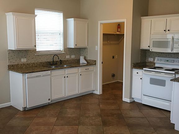 Kitchen with beautiful granite counter tops.