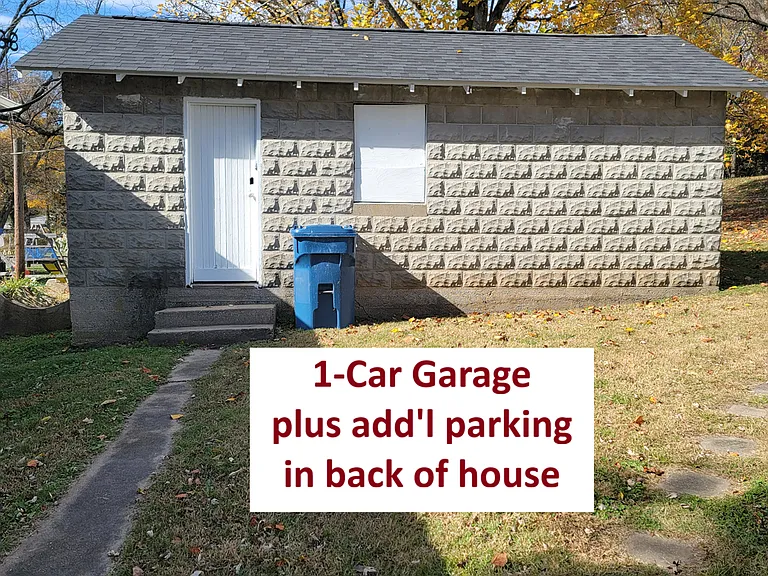 Electric Garage door opener. Work table space. Sidewalk from back door to the garage.