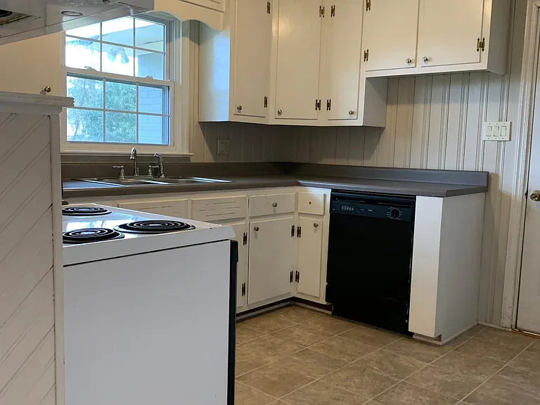 Kitchen. Dishwasher. Side by side refrigerator with ice maker and water dispenser.