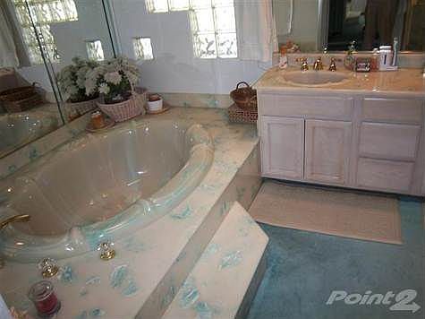 Master Bath in Master Bedroom says relax after a hard day in a nice big tub.