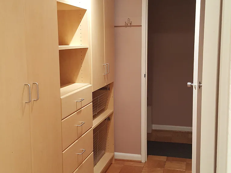 View from the bathroom door to the main hallway. The front door is to the left and the large picture window is to your right.