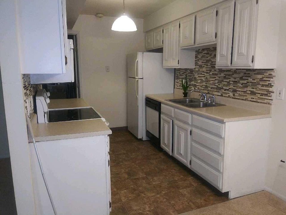 Kitchen with pantry and laundry room in the background