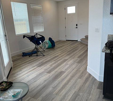 Bright open-concept living area with luxury vinyl plank flooring.