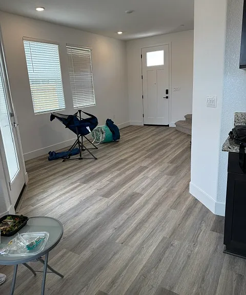 Bright open-concept living area with luxury vinyl plank flooring.