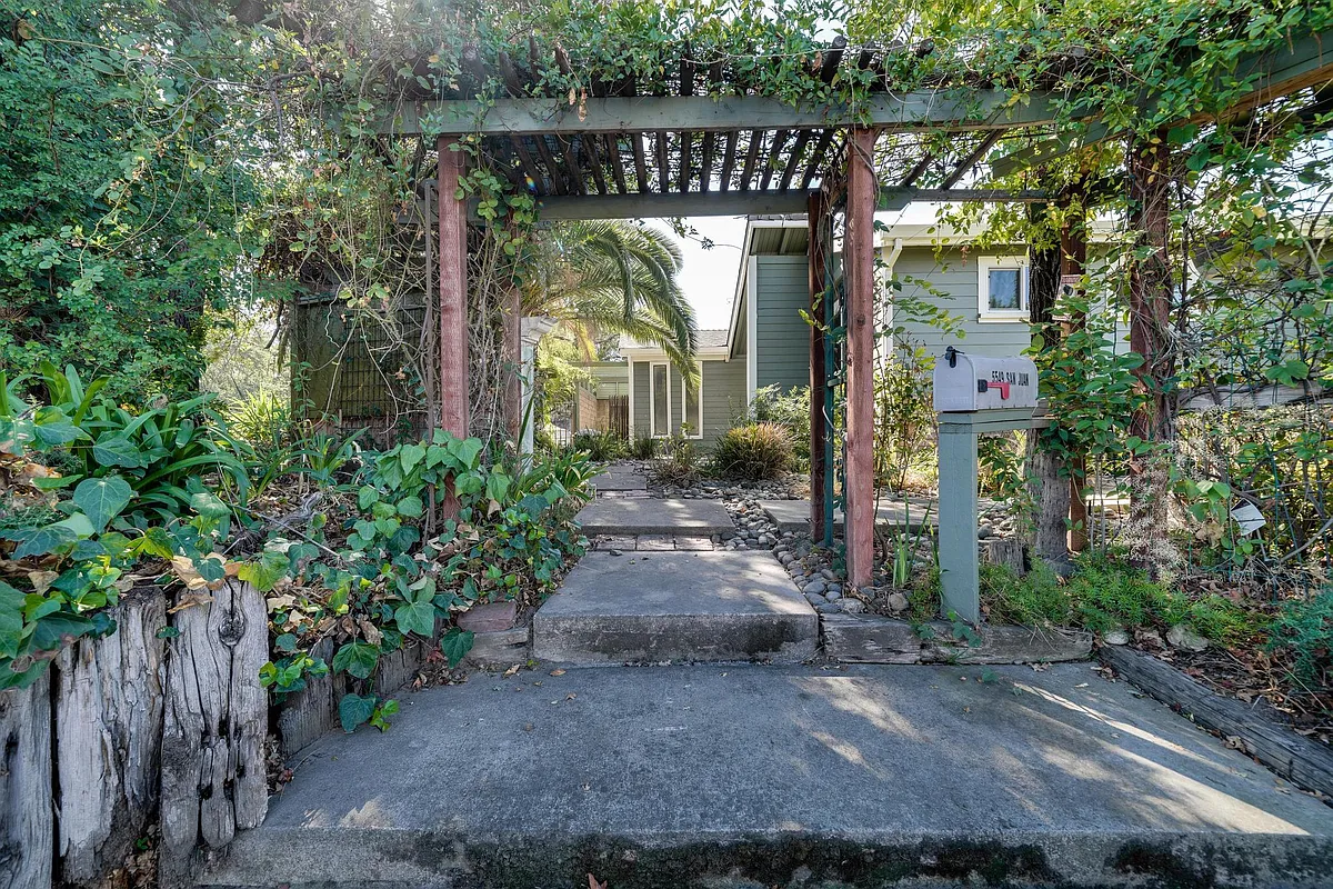 Path to front door. Mailbox with arched vine walkway. - 5549 San Juan Ave