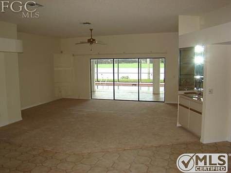 Living area, with wet bar and triple sliders  volume ceilings.