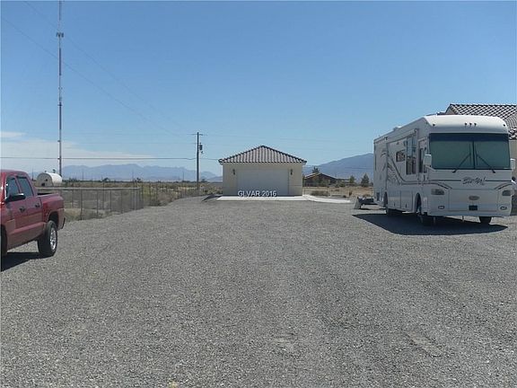 Left side of property to 4 car detached garage, which has been converted to a studio