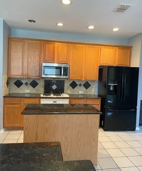 Kitchen. Great counter space, sizeable island w/cupboard space underneath. Microwave, oven/stove & refrigerator provided.
