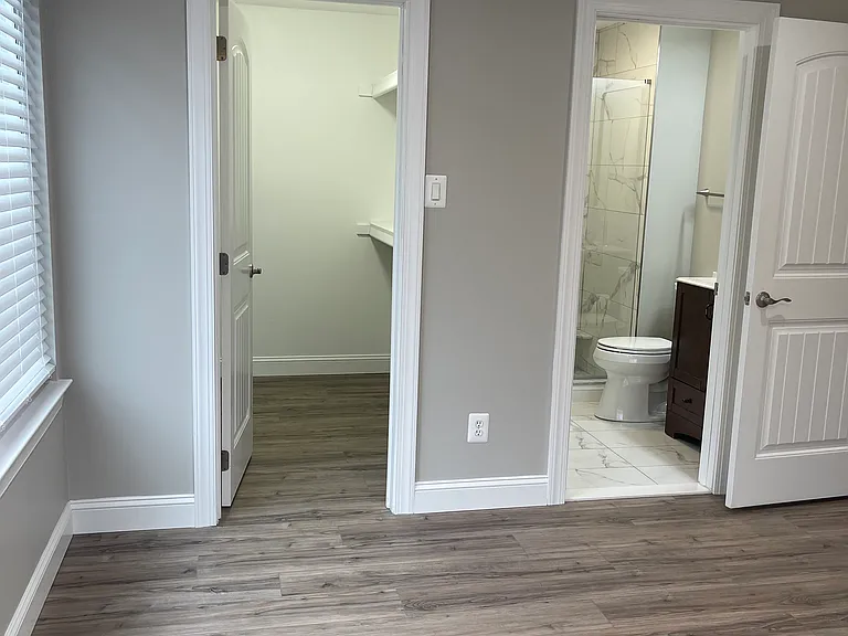 Primary Bedroom with on suite bathroom and shower and walk in closet