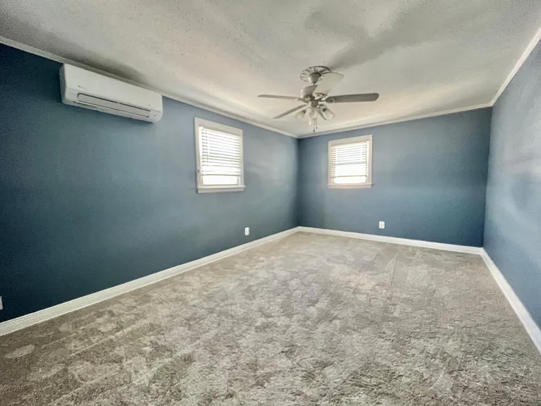 2023 Carpets. Units updated with Wall AC, ceiling fans, low e vinyl windows and custom paints. Front room may be bedroom or front living room,
