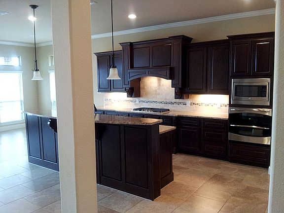 Amazing Gourmet Island Kitchen with Maple Glazed Cabinets with Under Lighting, & Sparkling Granite Counter Tops & Breakfast Bar with Pendant Lighting! Great Appliance Package!