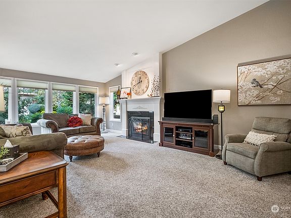 Vaulted ceilings throughout the main floor ... Anderson windows ... custom widow coverings. 1 of 3 gorgeous gas fireplaces. "We love gazing out the gorgeous windows onto our manicured lawn surrounded by professional landscaping.">