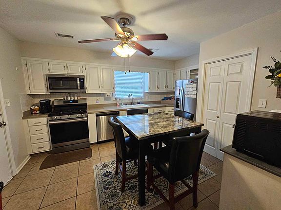 Large kitchen with new all-steel appliances, including gas range and side-by-side refrig with in-door ice maker. Doors lead to Laundry. Other door leads to over-sized two car garage.