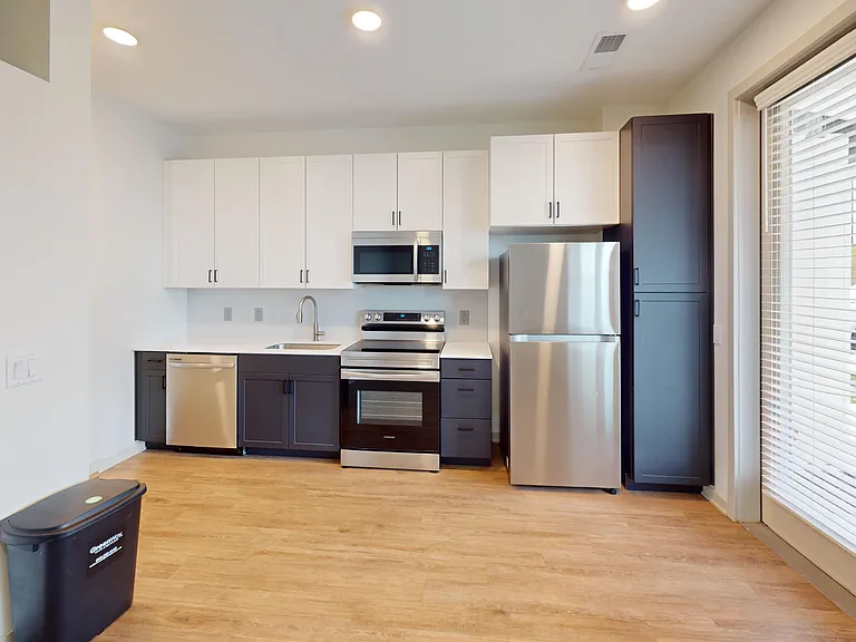 The Eleanor floor plan features stainless steel appliances, including a glass top stove, built-in microwave, and dishwasher. The Eleanor floor plan features stainless steel appliances, including a glass top stove, built-in microwave, and dishwasher.
