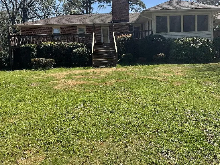 Back of house with large deck across the back of the house