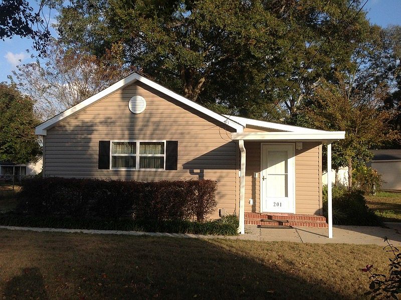 Covered front entry, sidewalks, lovely brick steps at front and back doors.