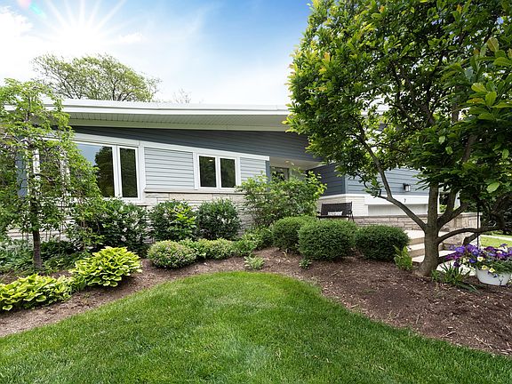 Perennial gardens surround the home & yard