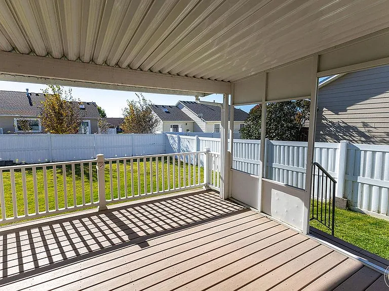 covered south facing patio to fenced back yard