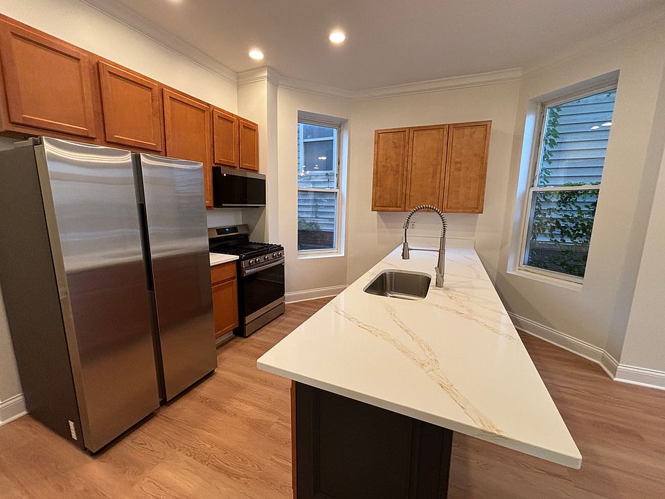 Main level kitchen with new quartz countertops and stainless steel appliances