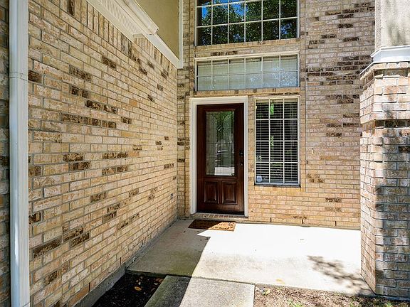 Leaded glass front door with soaring windows on the front of home. Light & Bright.