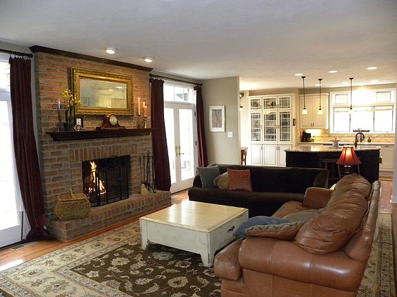 Family Room with Central Fireplace surrounded by French Doors