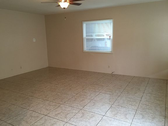 Spacious living area with tile flooring