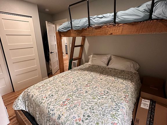 Bedroom with queen bed and twin bunk above