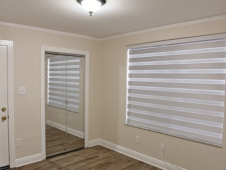 This again is a picture of the sister apartment. Just picture this office/bedroom with gorgeous hardwood oak floors, similar Zebra Blinds, behind the mirror doors is a spacious walk-in closet/laundry. The leftside door goes out to the upper balcony/porch.