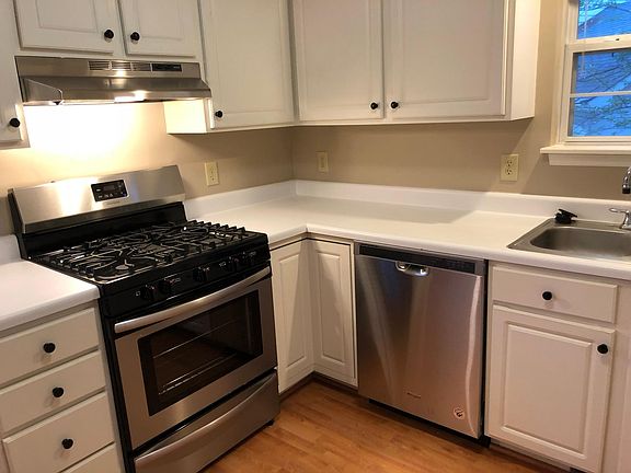 Kitchen with stainless steel gas oven. Stainless steel dishwasher.