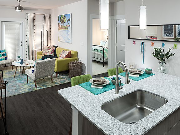 Select homes feature kitchen islands and either hardwood-style or stained concrete flooring