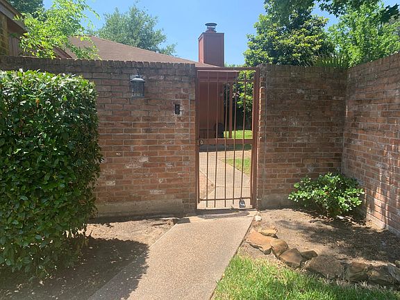 Walk up sidewalk to the locking front gate. Here is where you can enter to the huge yard.