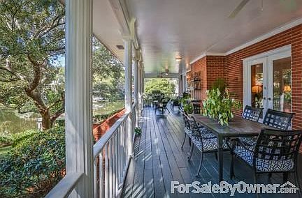 Large Covered Rear Porch : The porch is 12' by 52' long with separate sitting and dining areas.