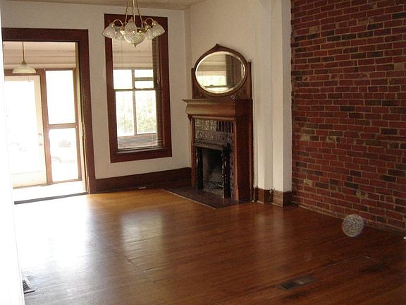 Living room toward fireplace, porch, and entrance