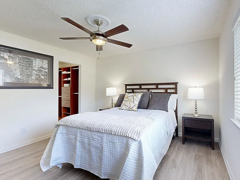 Bedroom with hardwood-style flooring & ceiling fan