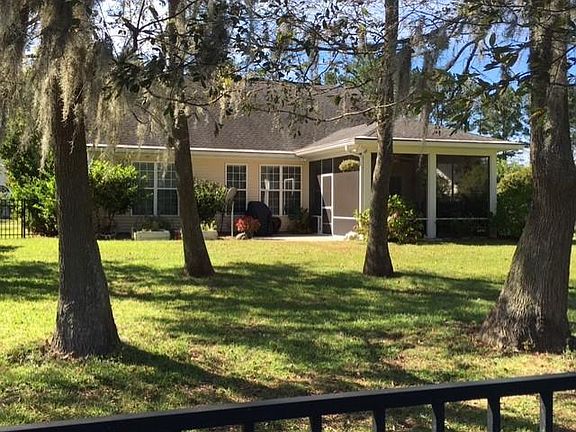 Fenced in backyard with view of gpolf course and lagoon