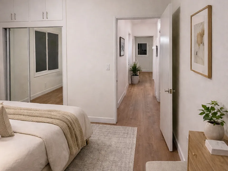 One of two bedrooms at unit 22 showing hallway that connects the two with a large bathroom that separates the two bedrooms