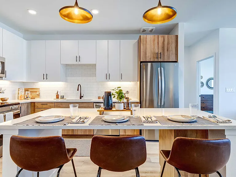 Cook and entertain with ease in a contemporary kitchen featuring stainless steel appliances, sleek cabinetry, and spacious island seating.