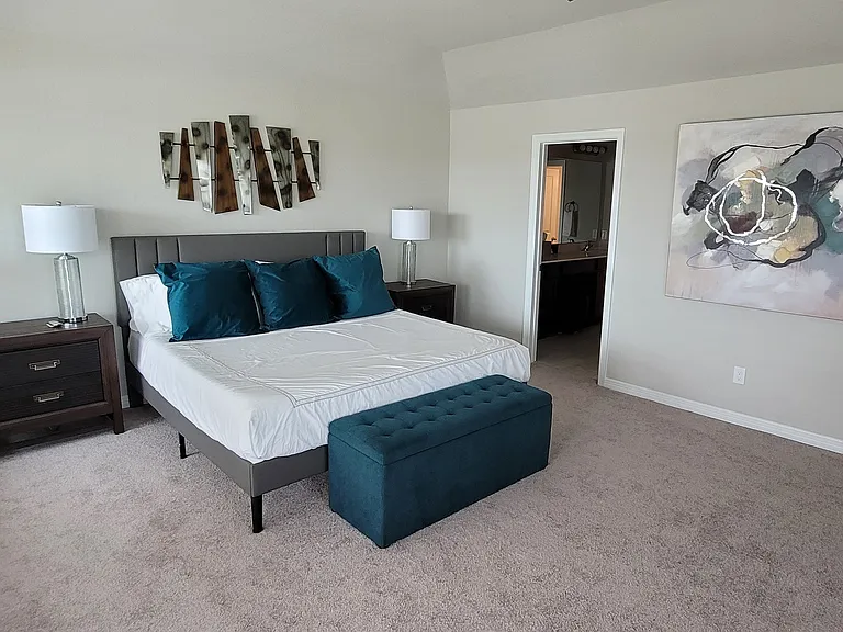 View of primary bedroom with bathroom entry way