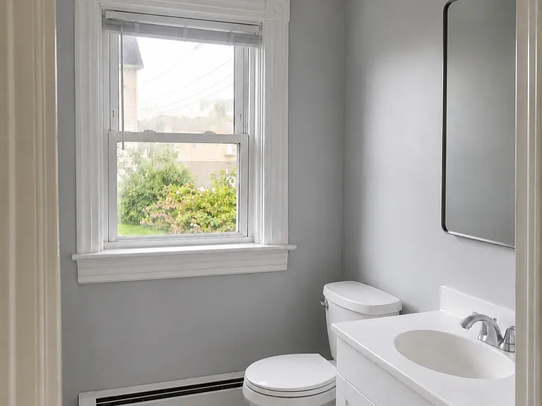 bathroom (full shower left of sink) - new floors, paint, and toilet.