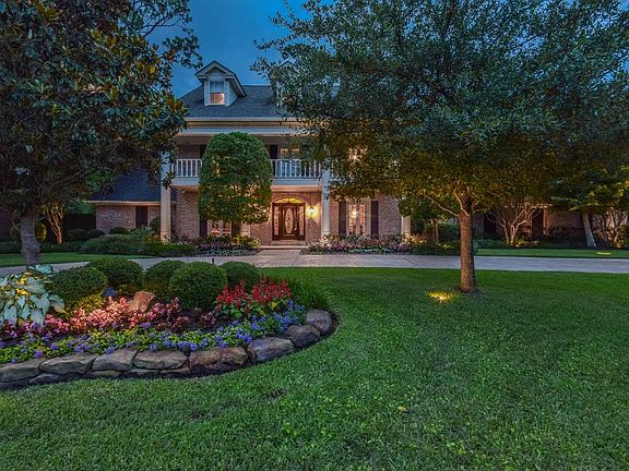 Manicured lawns and gardens and both up and down decorative lighting highlights the main features of this home.