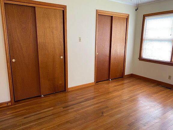 Bedroom with full wall of closets