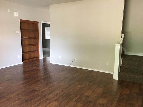 View of Master Bedroom Door across from Laundry and stairs to 2nd level.
