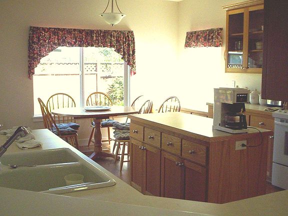 Gourmet Kitchen~Gas Range/Oven~Island~Built-In Pantry~Adjoining Dining Area & Desk~Deck through Slid